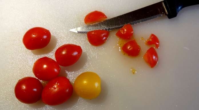 couper des tomates en petits dés pour colorer le Guacamole aux myrtilles